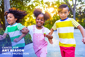 Three smiling, happy kids running.